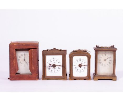 A GROUP OF FOUR MECHANICAL CARRIAGE TYPE CLOCKS two with alarms, one with a case together with two electric mantle clocks and