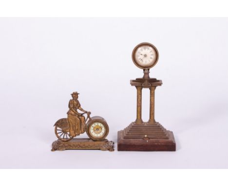 AN EDWARDIAN PARCEL GILT AND CAST BRASS NOVELTY MANTLE TIMEPIECE OR CLOCK in the form of a lady riding a bicycle, the movemen
