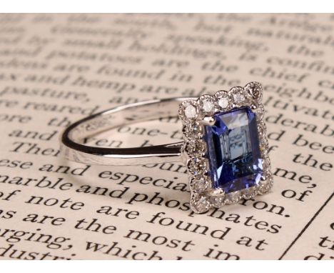 An 18ct white gold ring, set with emerald cut tanzanite and round brilliant cut diamonds, tanzanite 1.40ct, diamonds 0.40ct, 