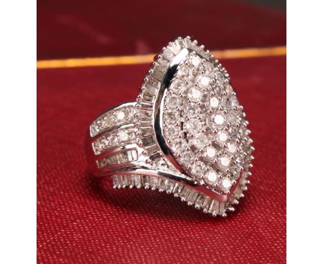A Large 9ct white gold navette swirl diamond cluster dress ring set with round brilliant and baguette-cut diamonds. total Dia