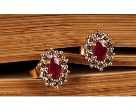 A pair of 9ct yellow and white gold oval ruby and RBC diamond cluster studs, boxed. Rubies 0.62ct. Diamonds 0.51ct