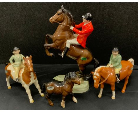 A Beswick huntsman on rearing horse, 868, 24.2cm high, Boy and girl on Palomino Pony, model No. 1500, gloss, 14cm high, other