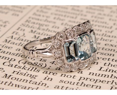 An 18ct white gold aquamarine and diamond ring, emerald-cut aquamarines 1.74ct, diamonds 0.26ct, size N