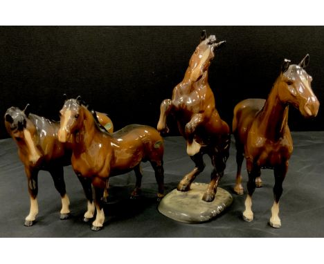 Beswick horses including; Welsh cob rearing, no.1014, others including bay horses, (4).