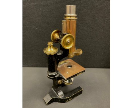 A late 19th century monocular microscope by C. Reichert Wein No 12014, brass and black lacquered body, three rotating lens ho