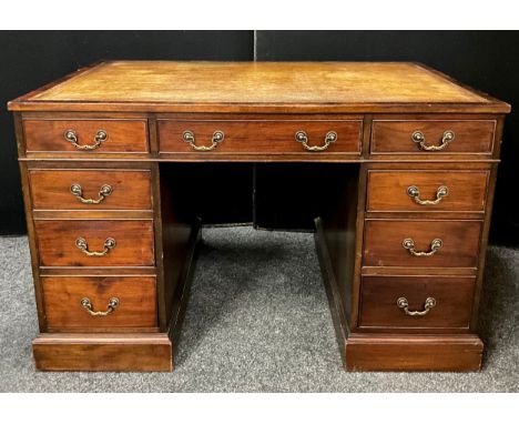 An early 20th century mahogany pedestal desk, tooled leather writing surface, four short drawers to each pedestal, single lon