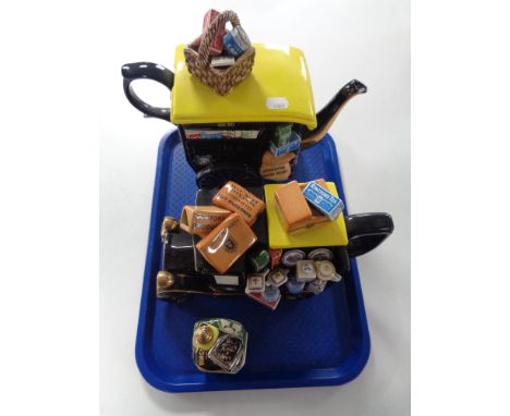 A tray containing two Ringtons novelty teapots, the Tea Merchant teapot No. 44 of 17,500 and the Ringtons Van teapot No. 959 