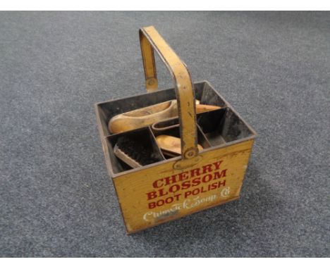 A vintage metal shoe-shine caddy containing brushes and bearing Cherry Blossom decoration 