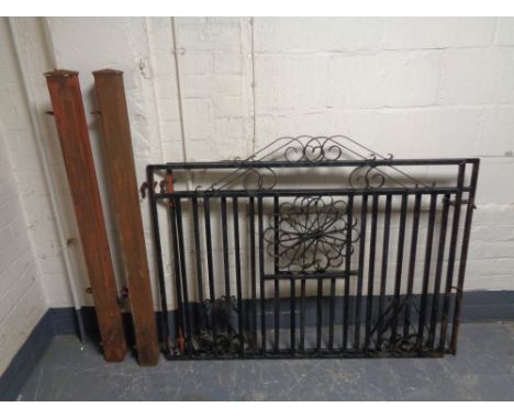 A pair of wrought iron gates with gate posts 