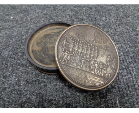 A continental white metal mounted snuff box, the lid depicting figures in a town square, diameter 76mm. 