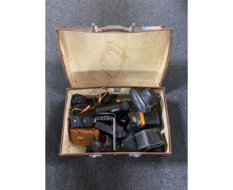 A vintage Revelation case containing assorted vintage cameras, lenses and accessories