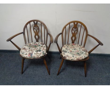 A pair of Ercol solid beech armchairs in an antique finish 