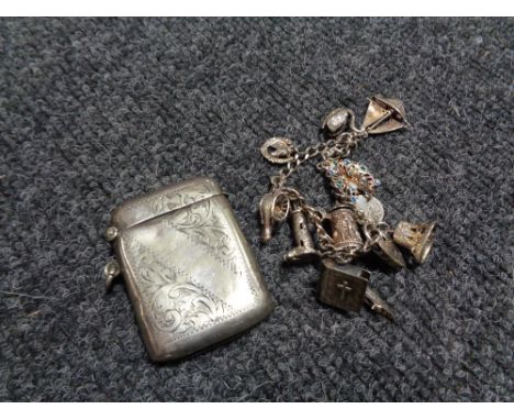 A vintage white metal charm bracelet together with a silver plated vesta case 