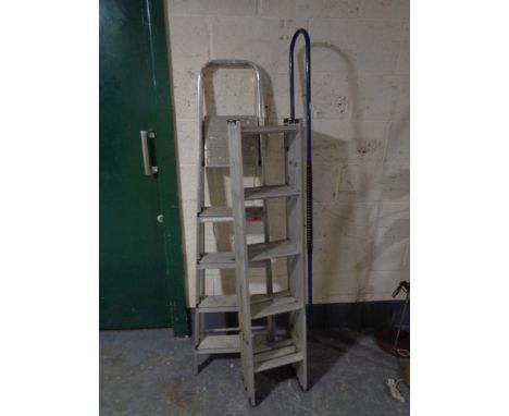 A triple aluminium extending ladder, with a set of aluminium folding steps 