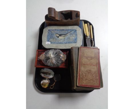 A tray containing glass paper weights, books, vintage ordinance survey map of Newcastle upon Tyne, wooden woodwork plane, cut