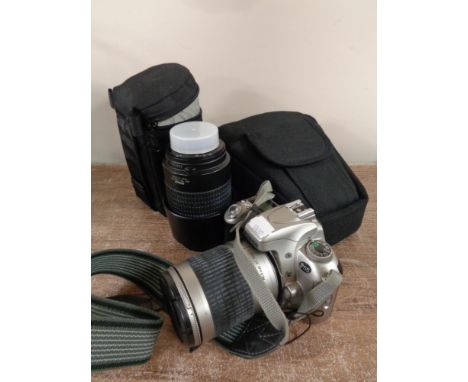 A Nikon F55 camera in case together with Nikon lens in fitted bag and other camera accessories 