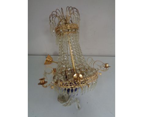 An early twentieth century brass five-way light fitting with blue glass shade and drops 