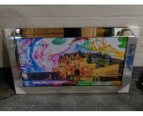 A framed print of Edinburgh castle with added decoration, in a mirrored frame 
