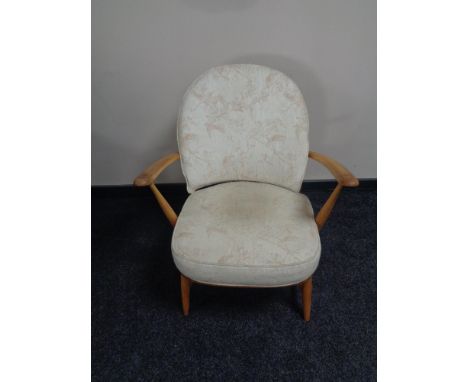 An Ercol solid elm and beech armchair 