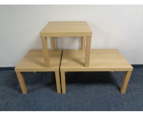 An Ikea coffee table, with a pair of matching lamp tables 