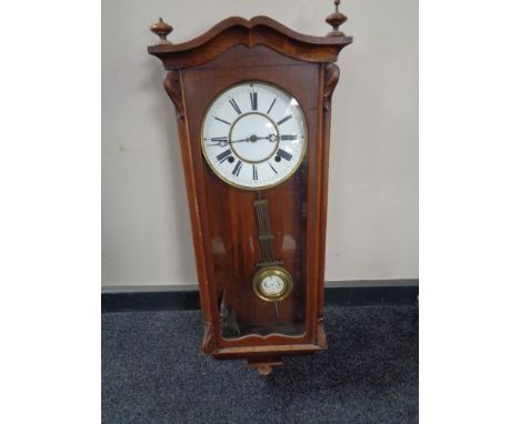 A 20th century eight day wall clock with pendulum and key 