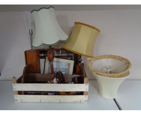 A box containing framed pictures, mid twentieth century teak table lamps, wooden book trough etc 