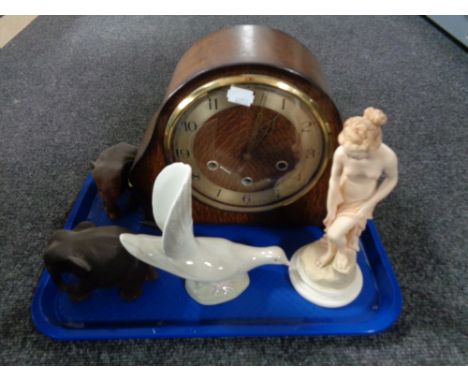 An oak cased Smith's mantel clock, two elephant carvings together with two further ornaments 