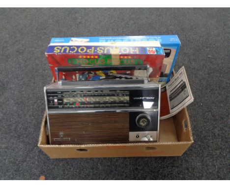 A box containing a Grundig yacht boy 210 radio with instructions, together with a board game and a magic set  