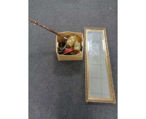 A gilt framed bevel edge hall mirror together with a box containing a brass carriage clock and lantern clock, a bed warming p