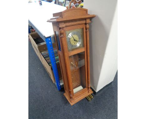 A contemporary oak cased Clockworks quarter chiming wall clock with weights and keys 