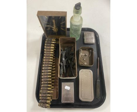 A tray containing 007 tin with die cast guns, cigarette case, bandolier of bullets, vintage glass bottle, German pin badges, 