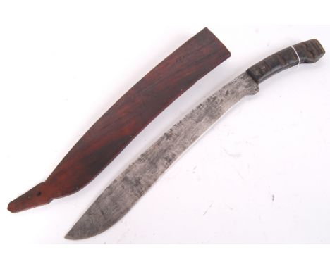 An antique 20th century wooden handled Filipino Bolas knife, within its original partially decorated scabbard. Measures appro