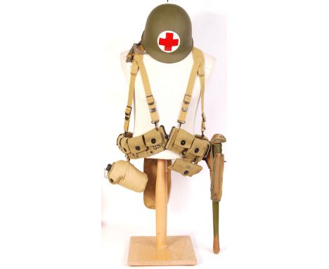A WWII Second World War style made-for-display US Airborne Troops Medic D-Day uniform display. Comprising of helmet, entrench