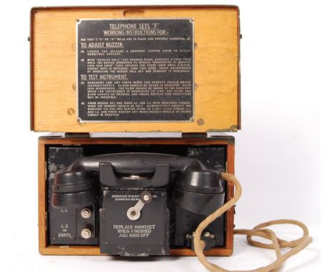 A WWII Second World War era vintage military issue cased field telephone, within its original wooden case. Stamped for ' Set 