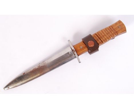 A WWII Second World War German Nazi Third Reich combat boot knife and scabbard, the knife having a wooden grip and the scabba