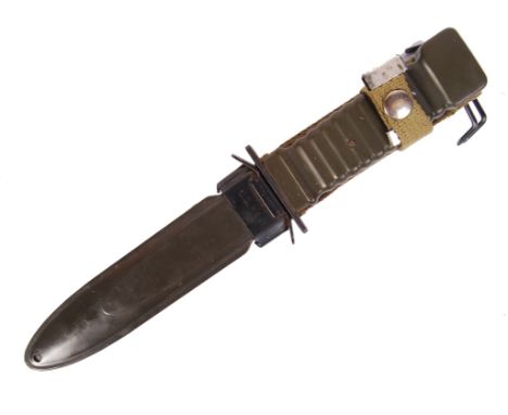 A US United States military M8A1 combat fighting knife with serrated edge and scabbard with attached cloth frog. Measures; 32