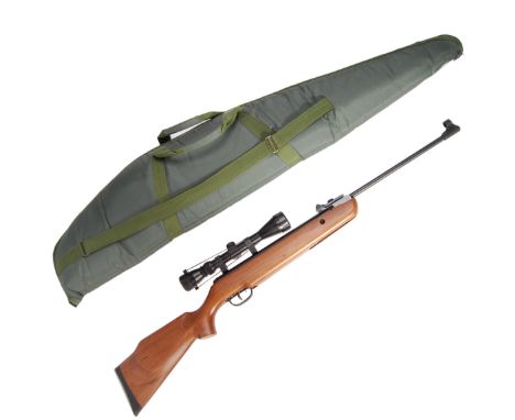 A SMK 19 .22 calibre break barrel air rifle with 3-9x40 telescopic scope / gun sight to top. Having a wooden stock and makers