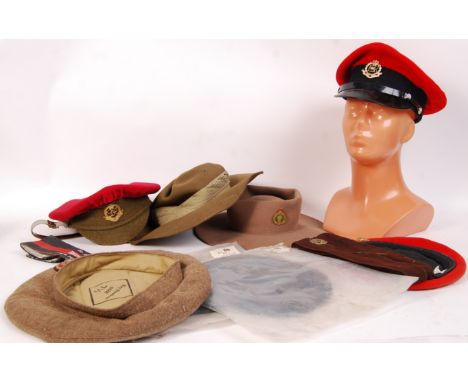 A collection of assorted post war British military uniform hats , caps and berets to include; ATS Auxiliary Territorial Servi
