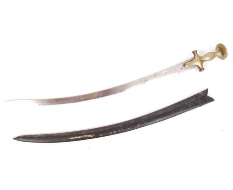 An antique 19th century Indian ' tulwar ' sword having a curved blade and a brass handle of typical form. With a rounded cros