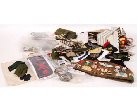 A collection of assorted reproduction and original WWII Second World War military patches , epaulettes and epaulette slides a