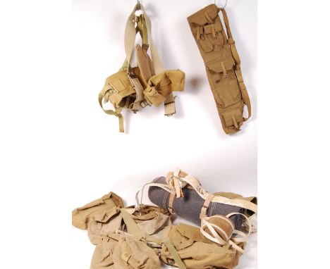 A collection of assorted military tropical khaki webbing and bags to include; a utility belt with attached canteen and other 