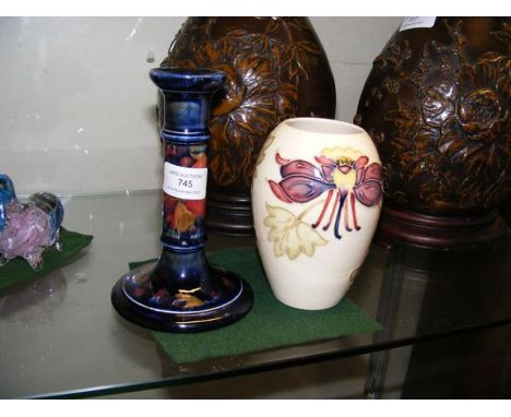 A Moorcroft Pottery 16.5cm high candlestick with 'Pomegranate' decoration, together with a Moorcroft Pottery vase