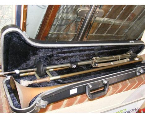 A Boosey &amp; Hawkes trombone in case together with K &amp; M stand