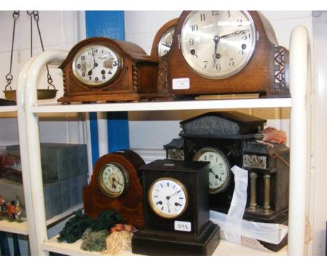 Three oak cased mantel clocks, two slate mantel clocks and an Edwardian mahogany mantel clock 