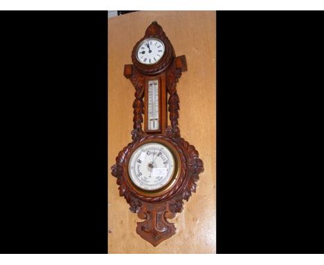 An antique oak cased barometer, clock, thermometer 
