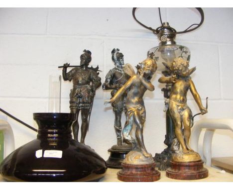 An antique oil lamp with glass shade, together with assorted miniature statues 