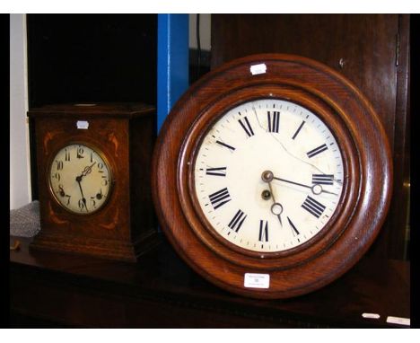A late Victorian oak circular wall clock with single train movement, together with an oak mantel clock