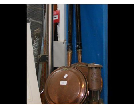 Two old bed warming pans, together with a miners lamp
