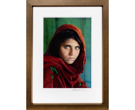 STEVE MCCURRY (AMERICAN b. 1950), SHARBAT GULA, AFGHAN GIRL, PAKISTAN  offset lithographic colour print, signed in pen lower 