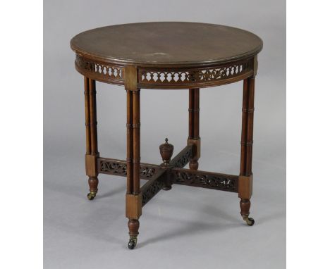 A Victorian mahogany circular centre table with moulded edge &amp; pierced column legs with turned feet &amp; ceramic castors